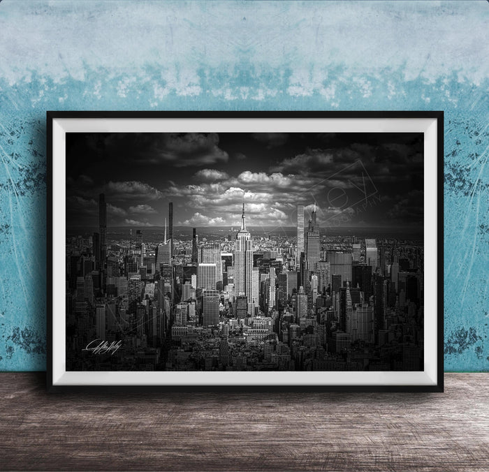 A black and white photograph of a cityscape, likely New York, with numerous tall buildings and skyscrapers in the background.