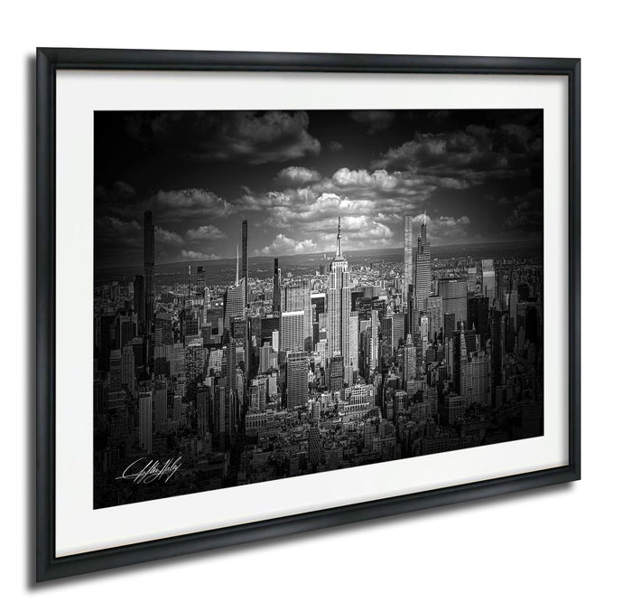 A black and white photograph of the New York City skyline, featuring the iconic Empire State Building and other skyscrapers.