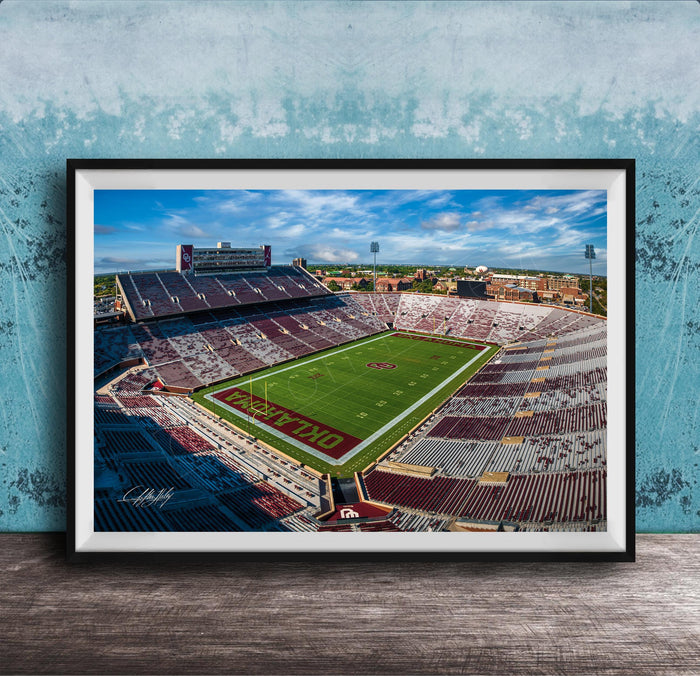 The image is a framed photograph of a football stadium, likely taken from an aerial perspective.