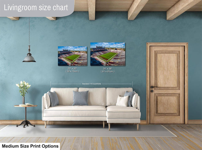 a living room with a white sofa, a wooden door, and a painting of a baseball stadium on the wall.