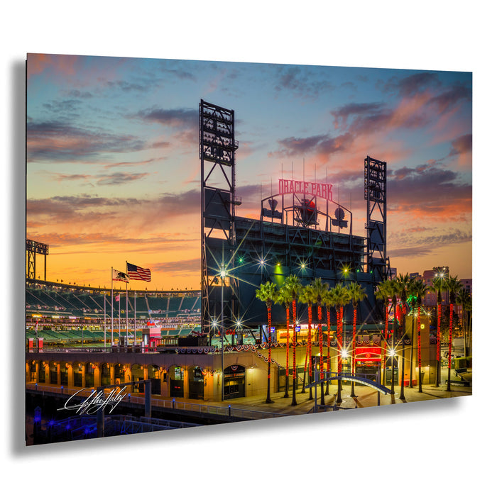A vibrant and colorful night scene at Oracle Park, with the stadium lights illuminating the field and surrounding area.