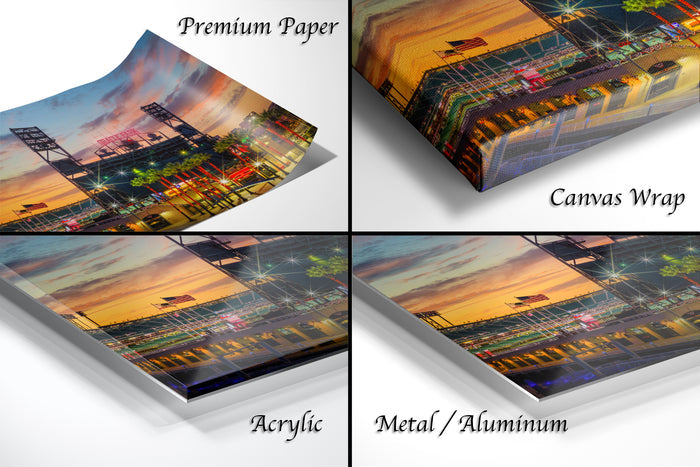 The image is a collage of four different views of a sunset over a baseball stadium, with each view presented in a different medium: premium paper, canvas wrap, acrylic, and metal/aluminum.