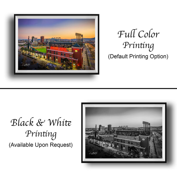 The image is a collage of two framed photographs. The top photograph is a full-color print of a city skyline at sunset, while the bottom photograph is a black and white print of the same city skyline. Both photographs are framed and available upon request.