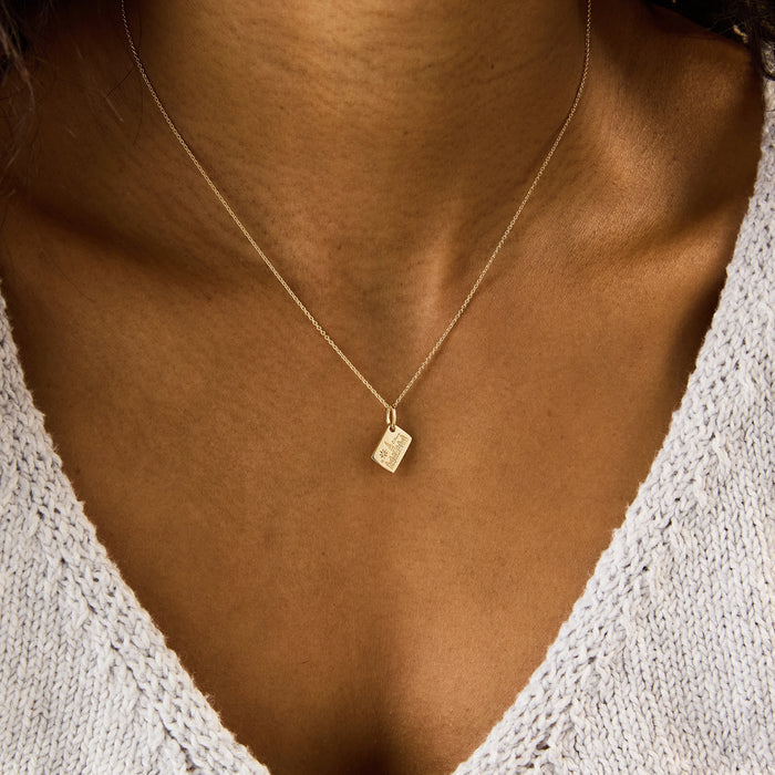 Ottawa Postcard Charm in 10k yellow gold with brilliant diamond, shown worn on hand