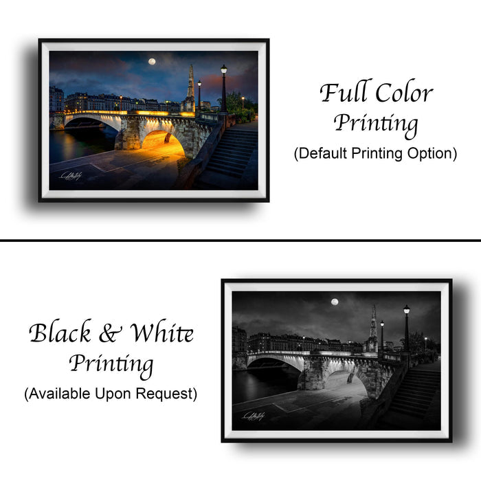 The image is a collage of two framed photographs. The top photograph is a full color print of a cityscape at night, featuring a bridge and a full moon. The bottom photograph is a black and white print of the same cityscape, with the same bridge and full moon visible. Both photographs are framed and displayed side by side, showcasing the contrast between the full color and black and white versions of the same scene.