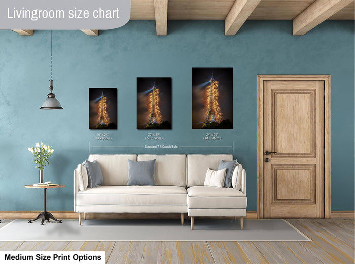 a living room with a white sofa, a wooden door, and a painting of a rocket launch. The living room has a blue wall and a wooden ceiling.