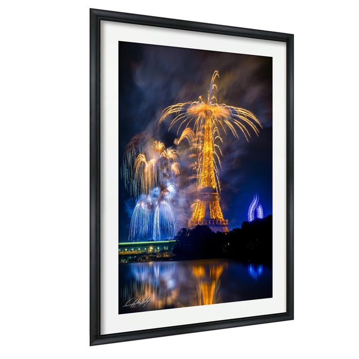a nighttime scene with a large, illuminated structure, possibly a tower or monument, surrounded by a vibrant display of colorful fireworks. The fireworks are reflected in the water below, creating a visually striking and dynamic scene.