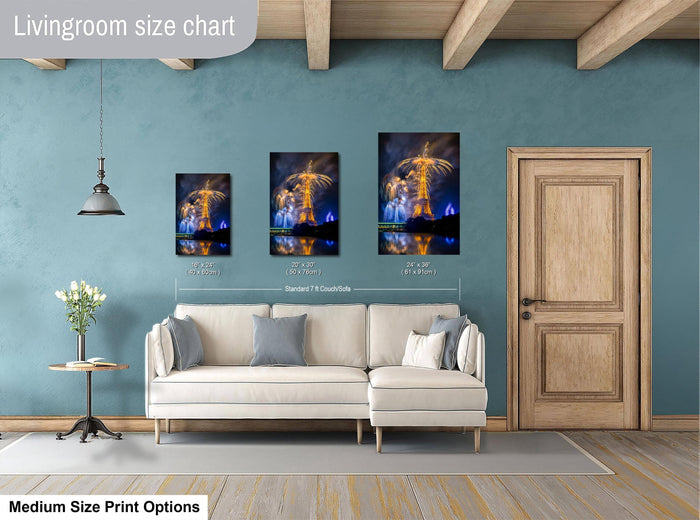 a living room with a white sofa, a wooden door, and a framed artwork of a fireworks display on the wall.