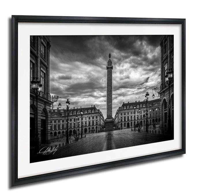 A black and white photograph of the obelisk in Paris, France, surrounded by historic buildings and a cloudy sky.