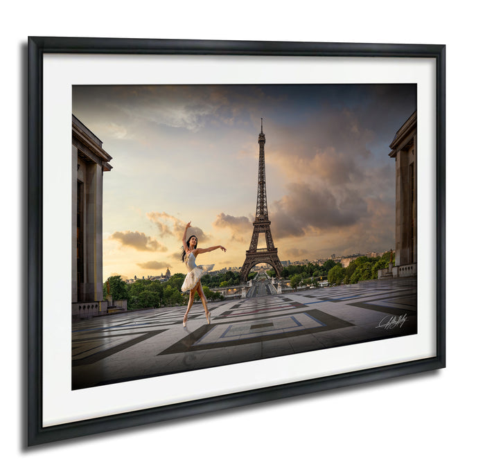 A woman in a white dress is dancing in front of the Eiffel Tower in Paris, France, with a dramatic sky in the background.