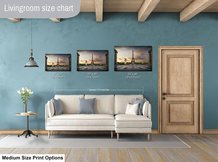 a living room with a white sofa and a wooden door. Above the sofa, there is a livingroom size chart that provides the dimensions of three framed artworks hanging on the wall.