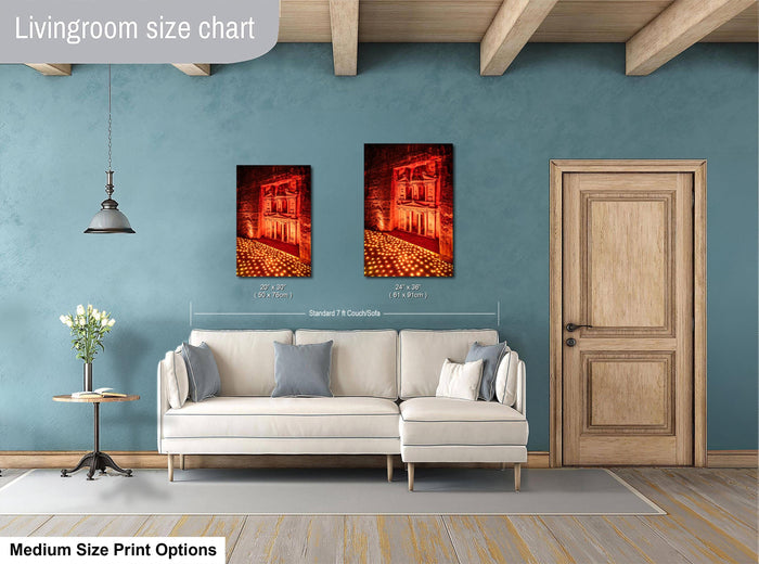 a living room with a white sofa, a wooden door, and a painting of a building with a red roof. The painting is hung on the wall above the sofa, and the sofa is positioned in front of the painting.
