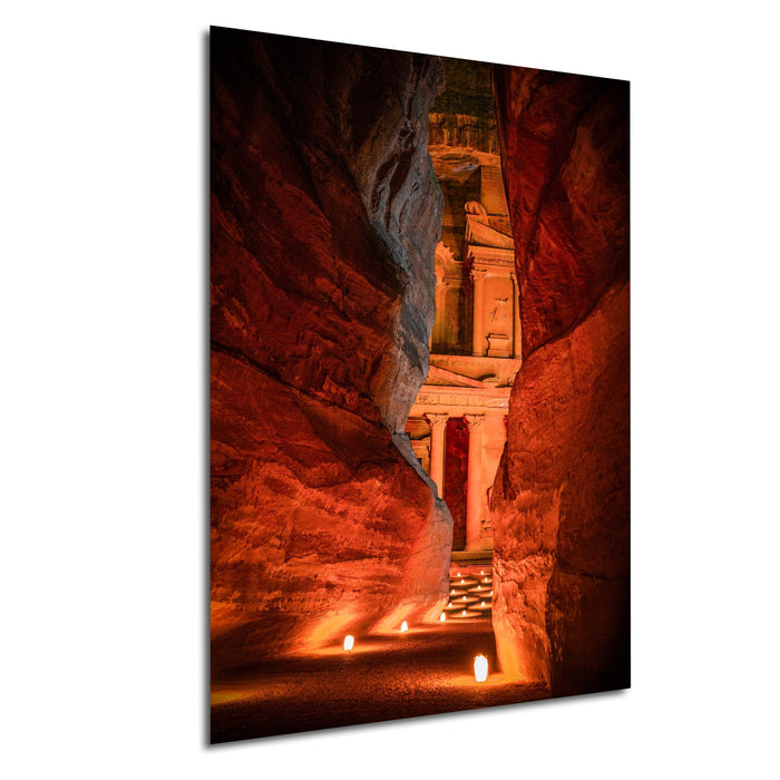 a cave with a stone structure illuminated by candles, creating a warm and inviting atmosphere.