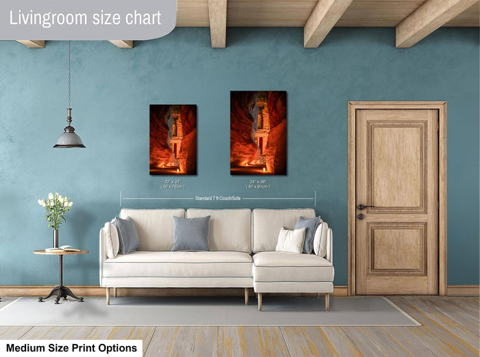 a living room with a white sofa, a wooden door, and a painting hanging on the wall. The painting is of a person standing in a cave with a red glow. The living room appears to be modern and well-decorated.