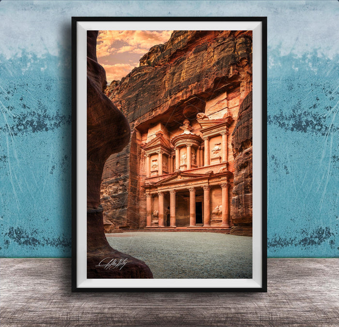A framed photograph of the ancient ruins of Petra, a famous archaeological site in Jordan, featuring the iconic Treasury of the Kings carved into the rock face.