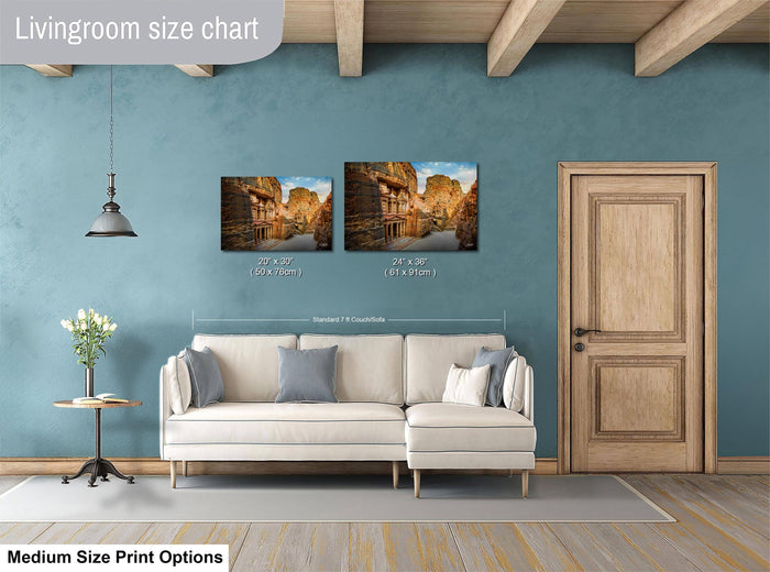 a living room with a white sofa, a wooden door, and a painting of a city street on the wall. The living room appears to be well-lit and decorated with a potted plant and a vase.