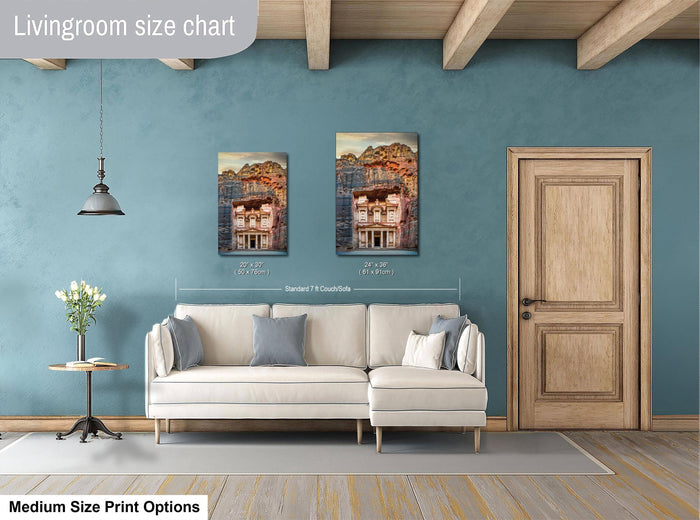 a living room with a white sofa, a wooden door, and a painting of a building on the wall. The painting is of a house with a red roof and a balcony. The living room appears to be well-lit and decorated with a vase of flowers on a table.