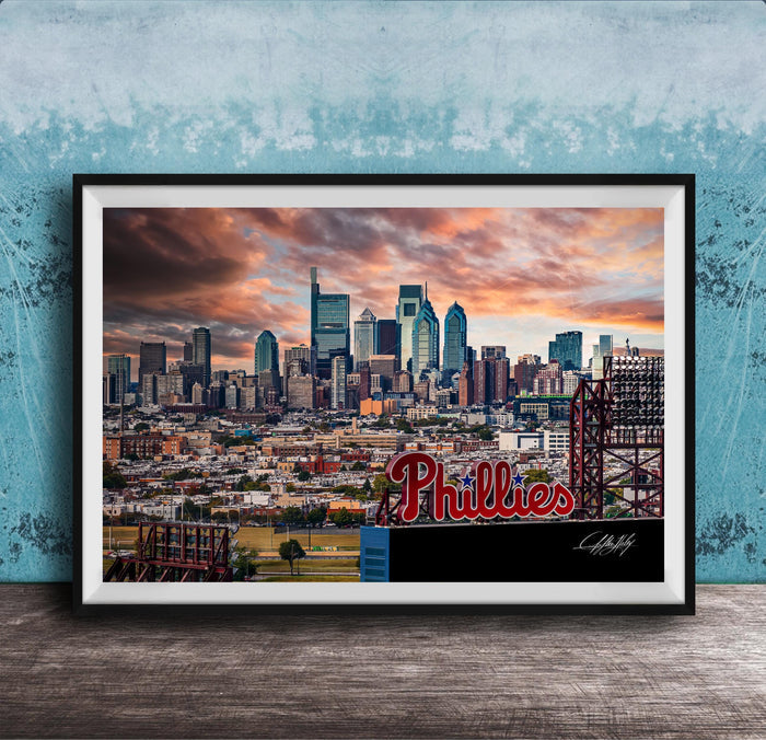 A framed photograph of the Philadelphia skyline at sunset, with the word "Phillies" prominently displayed in the foreground.