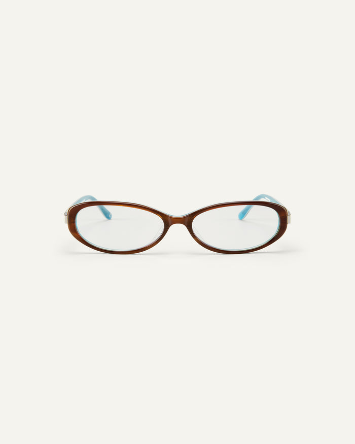 Face shot of Bonnie Clyde Pixie optical frames in layered teal demi with clear lenses.