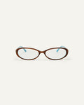 Face shot of Bonnie Clyde Pixie optical frames in layered teal demi with clear lenses.