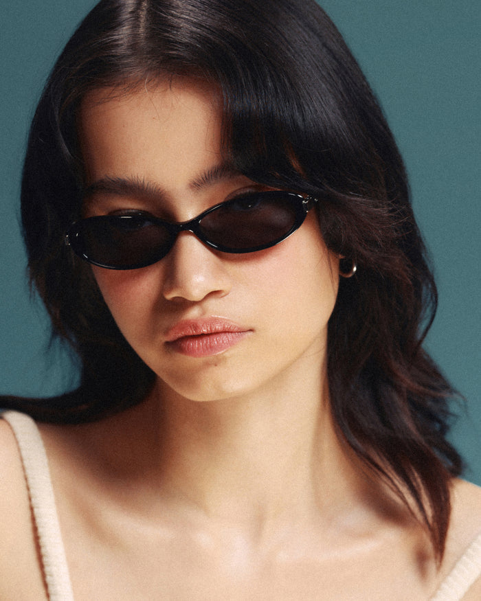 Quarter shot of Bonnie Clyde Pixie sunglasses in black with black lenses.