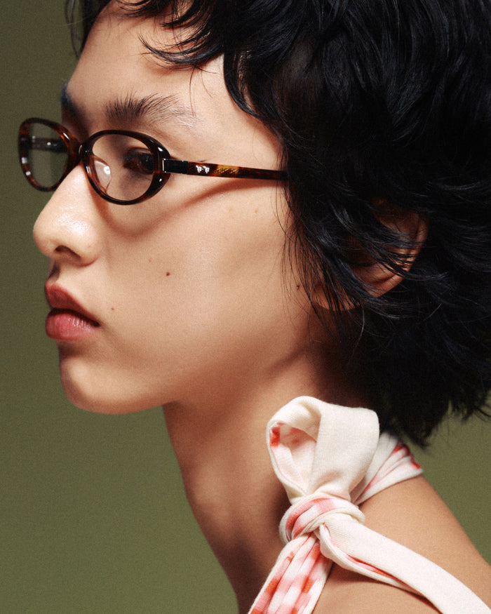Side shot of Bonnie Clyde Pixie optical frames in tortoise with clear lenses.