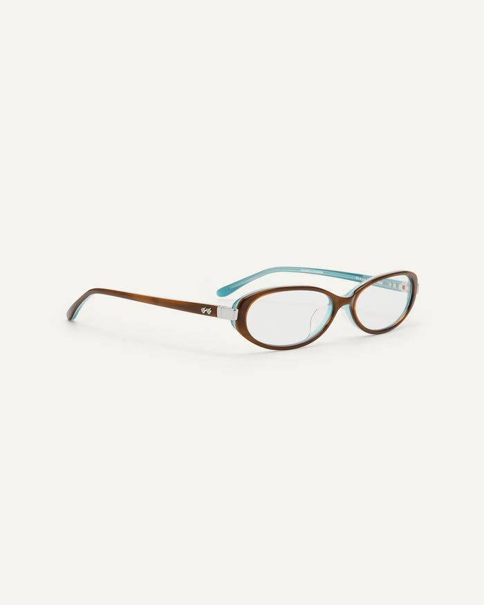 Side shot of Bonnie Clyde Pixie optical frames in layered teal demi with clear lenses.