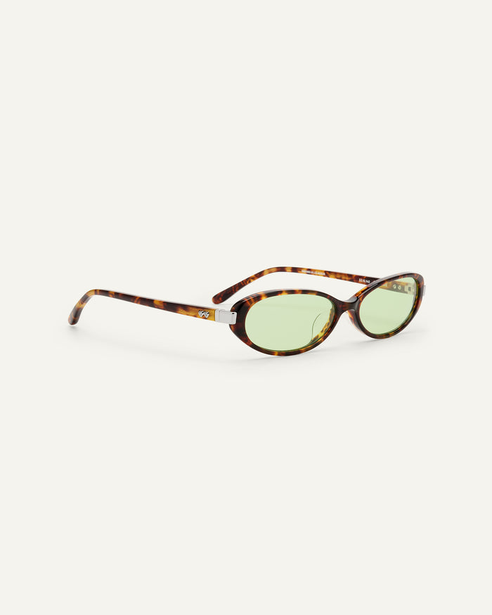 Side shot of Bonnie Clyde Pixie sunglasses in tortoise with green lenses.