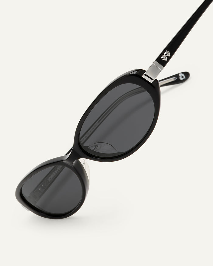 Close-up shot of Bonnie Clyde Pixie sunglasses in black with black lenses.
