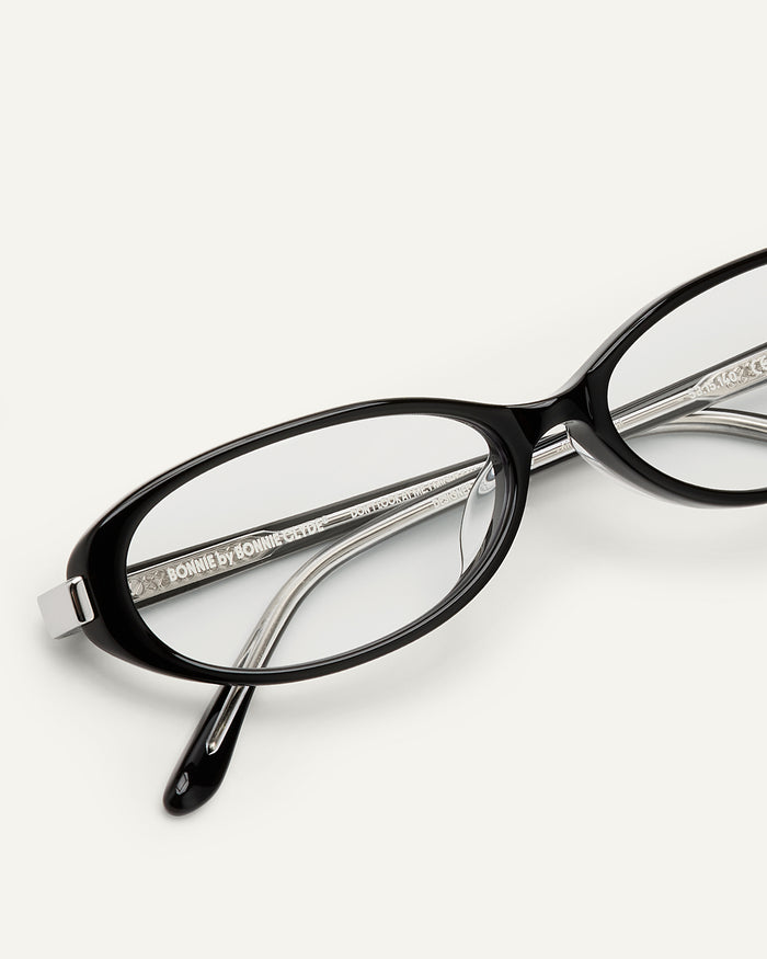 Close-up shot of Bonnie Clyde Pixie optical frames in black with clear lenses.