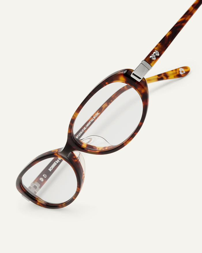 Detail shot of Bonnie Clyde Pixie optical frames in tortoise with clear lenses.