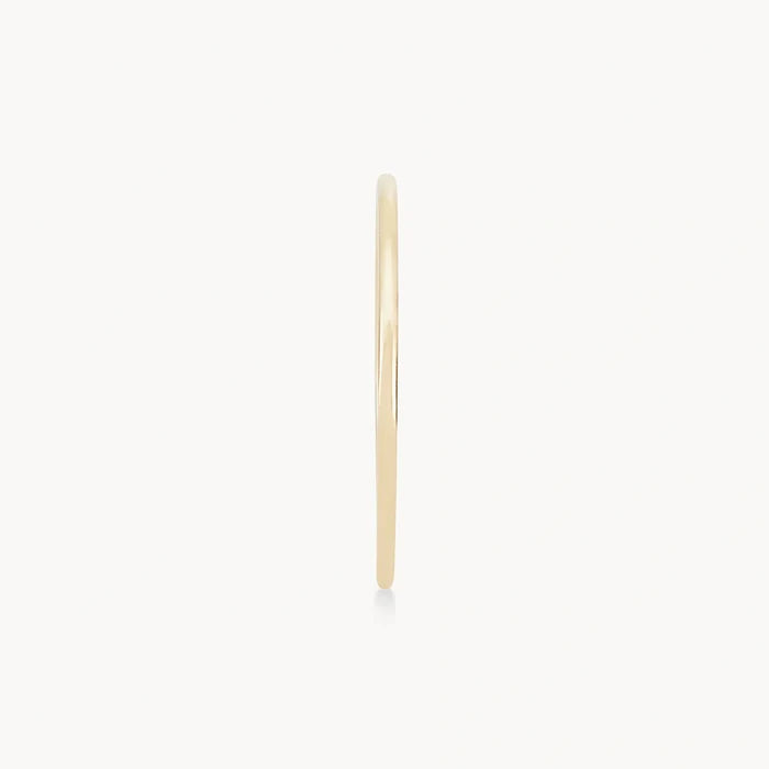 Side view of the plain jane stacking ring - 10k yellow gold by bluboho against a white background. The ring features a simple and elegant design with a smooth surface.