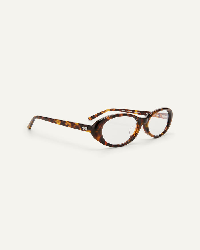 Quarter shot of Bonnie Clyde Pop Life sunglasses in tortoise with clear lenses.