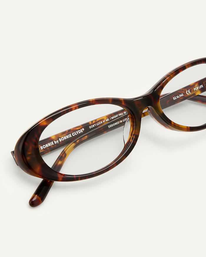 Side shot of Bonnie Clyde Pop Life sunglasses in tortoise with clear lenses.