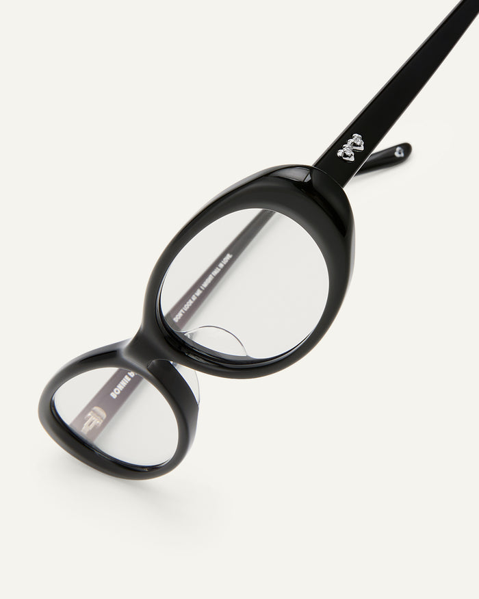 Side shot of Bonnie Clyde Pop Life sunglasses in black with clear lenses.