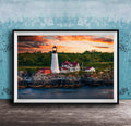 A framed photograph of a lighthouse on a rocky shore, with a colorful sunset sky in the background.