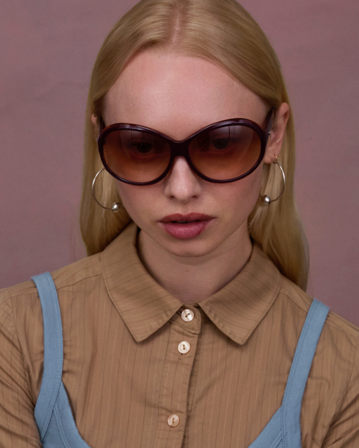 Quarter shot of Bonnie Clyde Princessa sunglasses in layered purple and brown with brown gradient lenses.