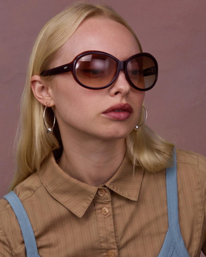 Side shot of Bonnie Clyde Princessa sunglasses in layered purple and brown with brown gradient lenses.