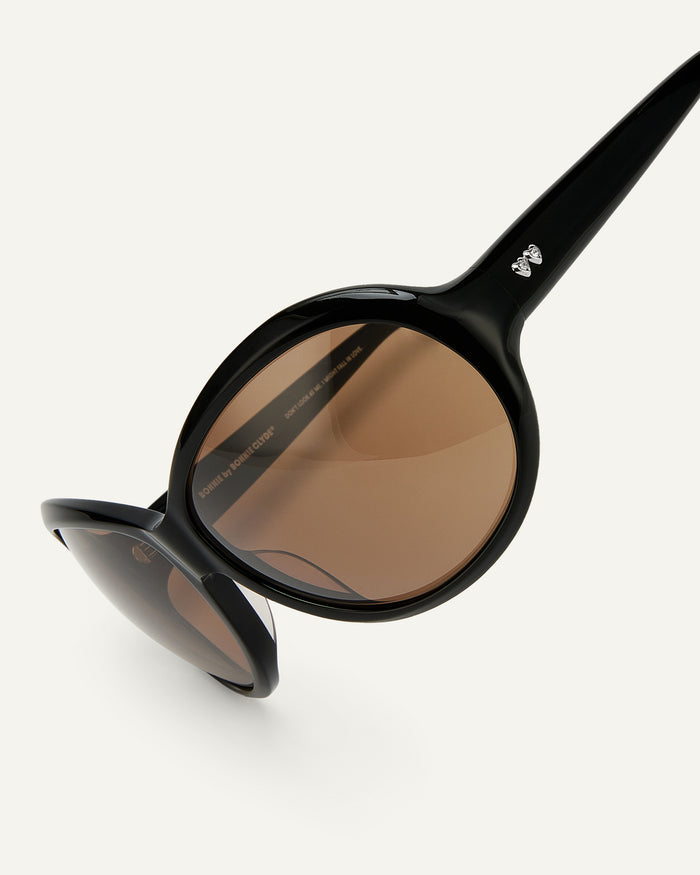 Close-up shot of Bonnie Clyde Princessa sunglasses in black with brown lenses.