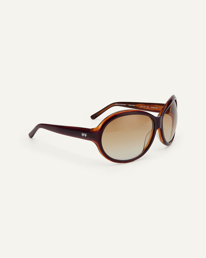 Close-up shot of Bonnie Clyde Princessa sunglasses in layered purple and brown with brown gradient lenses.