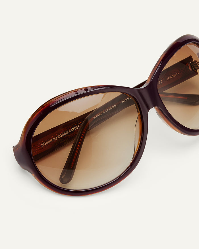 Detail shot of Bonnie Clyde Princessa sunglasses in layered purple and brown with brown gradient lenses.