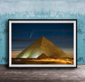 A framed photograph of the Great Pyramid of Giza at night, with a bright star visible in the sky above the pyramid.