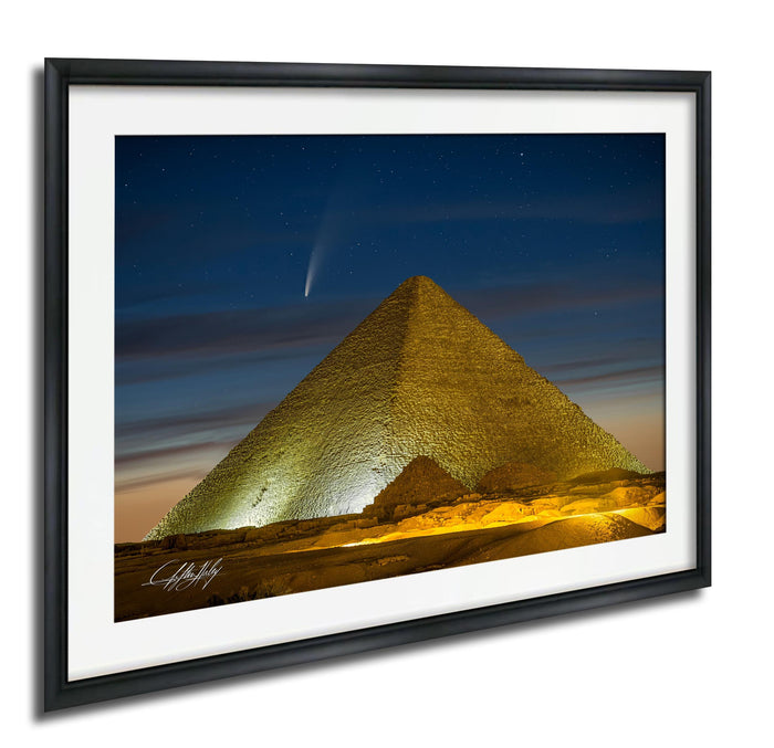 a large pyramid illuminated at night, with a bright star visible in the sky above it.
