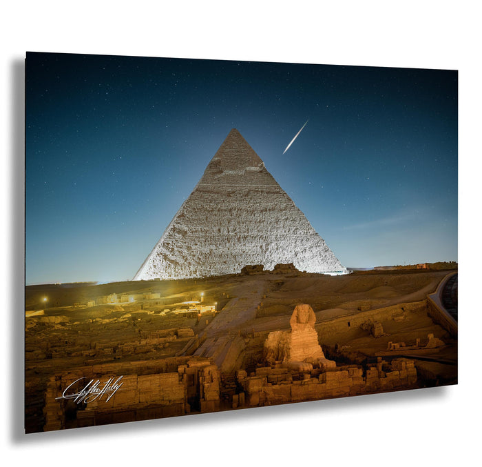 the Great Pyramid of Giza, a famous ancient Egyptian monument, illuminated at night against a starry sky.