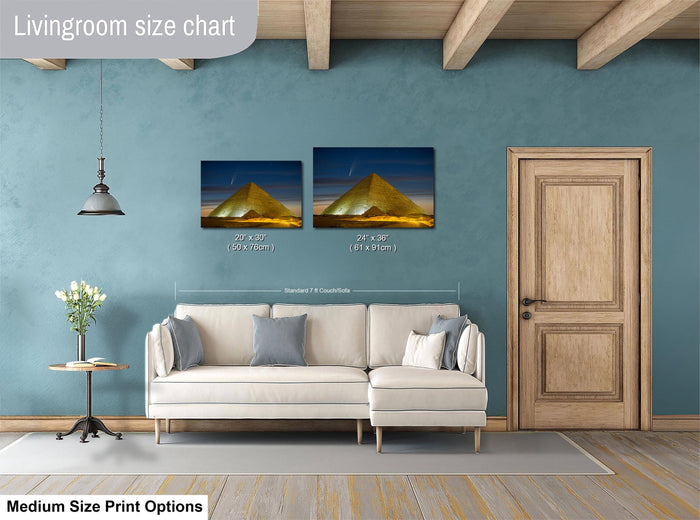 a living room with a white sofa, a wooden door, and a painting of a pyramid on the wall. The painting is of a size chart, indicating the dimensions of the artwork in relation to the sofa.
