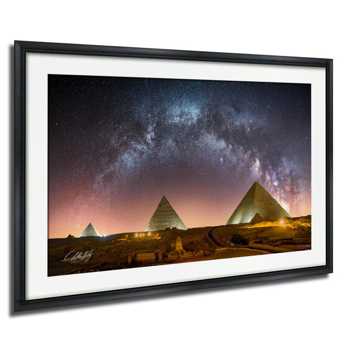 the iconic pyramids of Giza in Egypt, illuminated against a starry night sky.