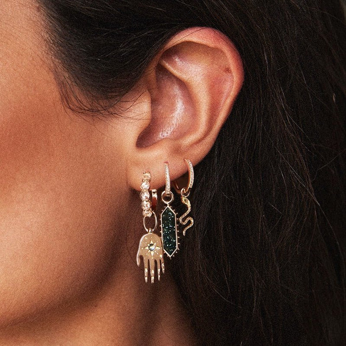 Revival Snake Green Tourmaline Earring Charm in 10k yellow gold with natural green tourmaline gemstone, studio detail view