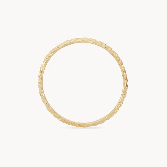 A bluboho revival stacking ring - 14k yellow gold with a subtle leaf pattern engraved along its outer surface, displayed on a plain white background.