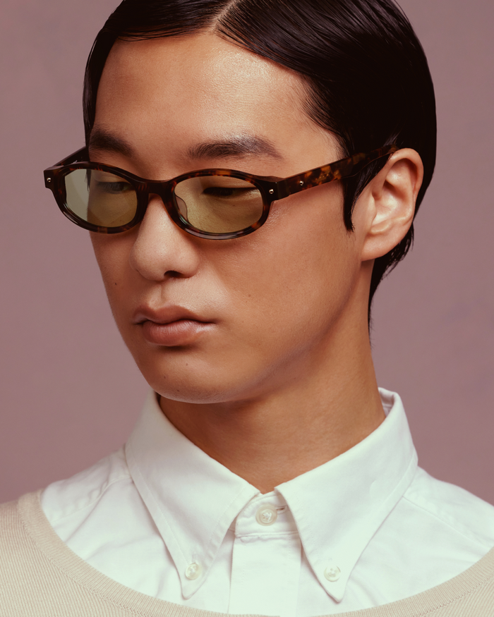 Quarter shot of Bonnie Clyde Roller Coaster sunglasses in tortoise with green lenses.