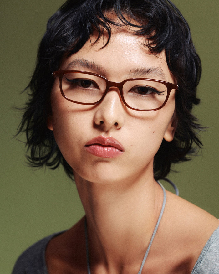 Quarter shot of Bonnie Clyde Rookie optical frames in brown with clear lenses.